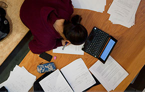 Student writing on piece of paper.